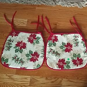 Two Christmas poinsettia chair pads.